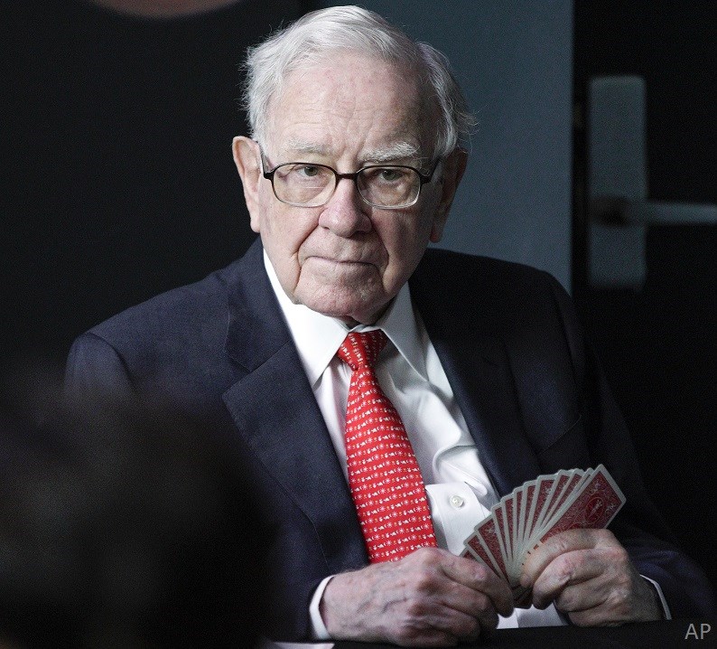 Warren Buffett holding cards